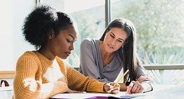 Counselor helping a student at a table